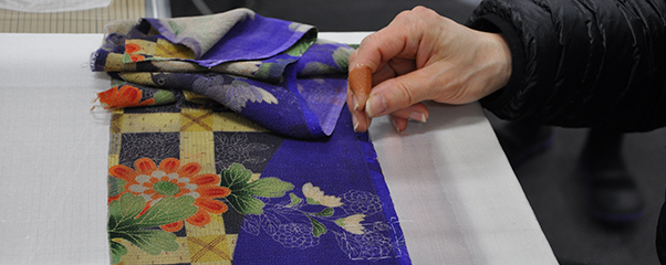 Bamboo fence and chrysanthemum design on a purple chirimen fabric