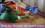 Pour the dye over the stencil paper