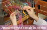 Arrange the warps through the heddles